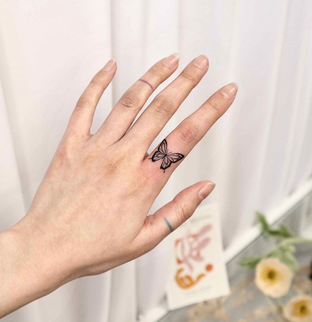 Small butterfly tattoos on finger